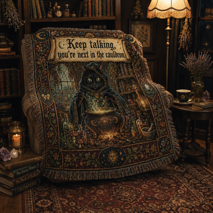 Black cat cauldron woven blanket styled over an armchair in a witchy reading nook