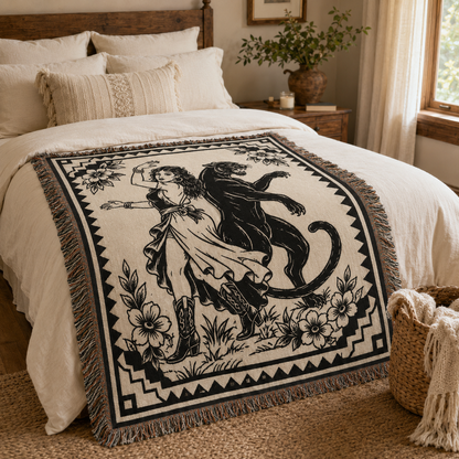 Black panther and dancer woven blanket styled across a bed