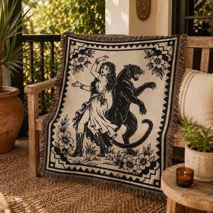 Black panther woven blanket styled on a sunlit patio chair