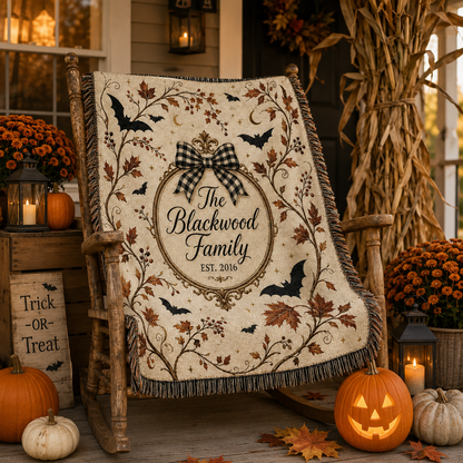 Personalized Halloween family name woven blanket displayed on a rustic autumn porch