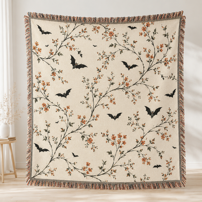 Botanical bat Halloween woven blanket with ivory background orange blossoms and fringe