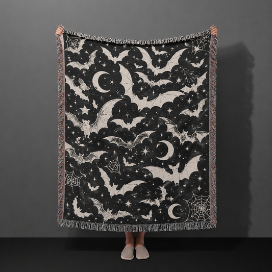 Black and ivory celestial bat Halloween woven throw blanket with moons stars and spiderwebs
