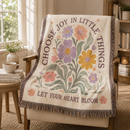 Pastel floral Choose Joy woven blanket displayed on a reading chair