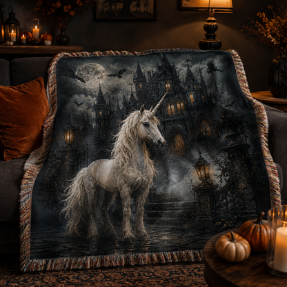 Gothic unicorn haunted castle woven blanket draped softly over a dark sofa with pumpkins candles and fringe