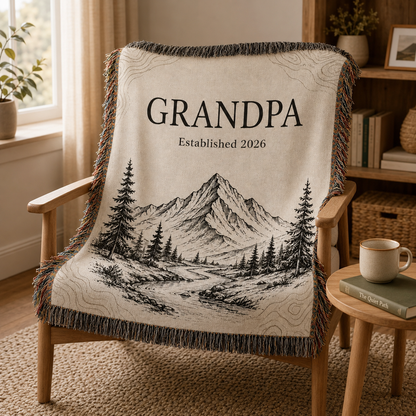 Grandpa mountain woven blanket draped over a wooden reading chair