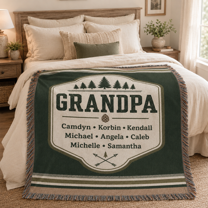 Custom Grandpa woven blanket with grandchildren names styled on a bed