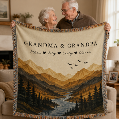 Grandma and Grandpa holding a personalized woven blanket with grandchildren names