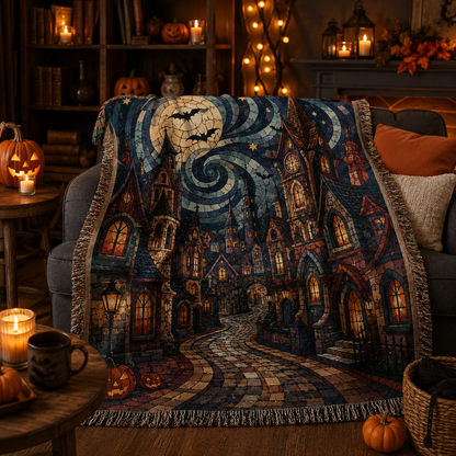 Haunted village Halloween woven blanket draped softly on a sofa