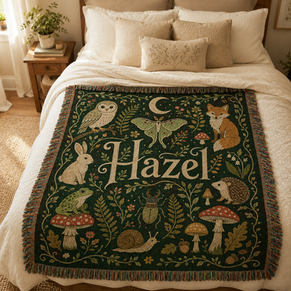 Personalized woodland name woven blanket styled across a cozy neutral bedroom bed