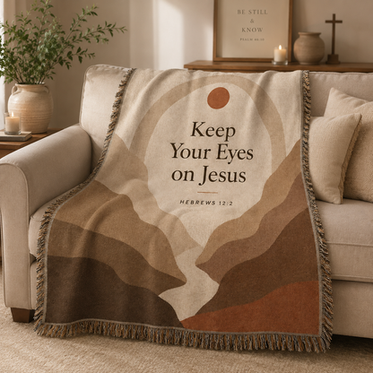 Hebrews 12:2 Keep Your Eyes on Jesus woven blanket softly draped over a neutral sofa with natural folds
