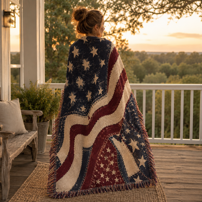 Woman wrapped in a vintage Americana woven blanket on a porch at golden hour