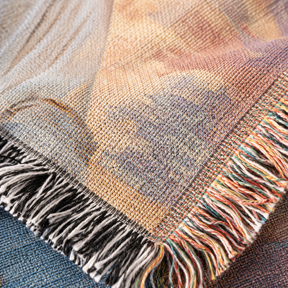 Macro close-up of woven yarn texture and multicolor fringe on Jesus sunrise blanket