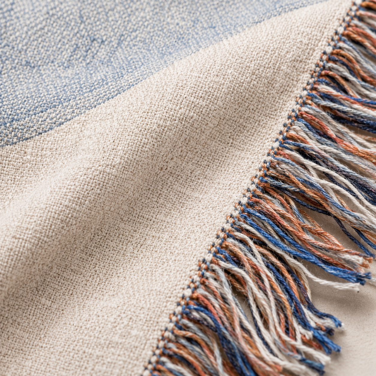 Macro close-up of woven yarn texture and multicolor fringe on John 14:27 blanket