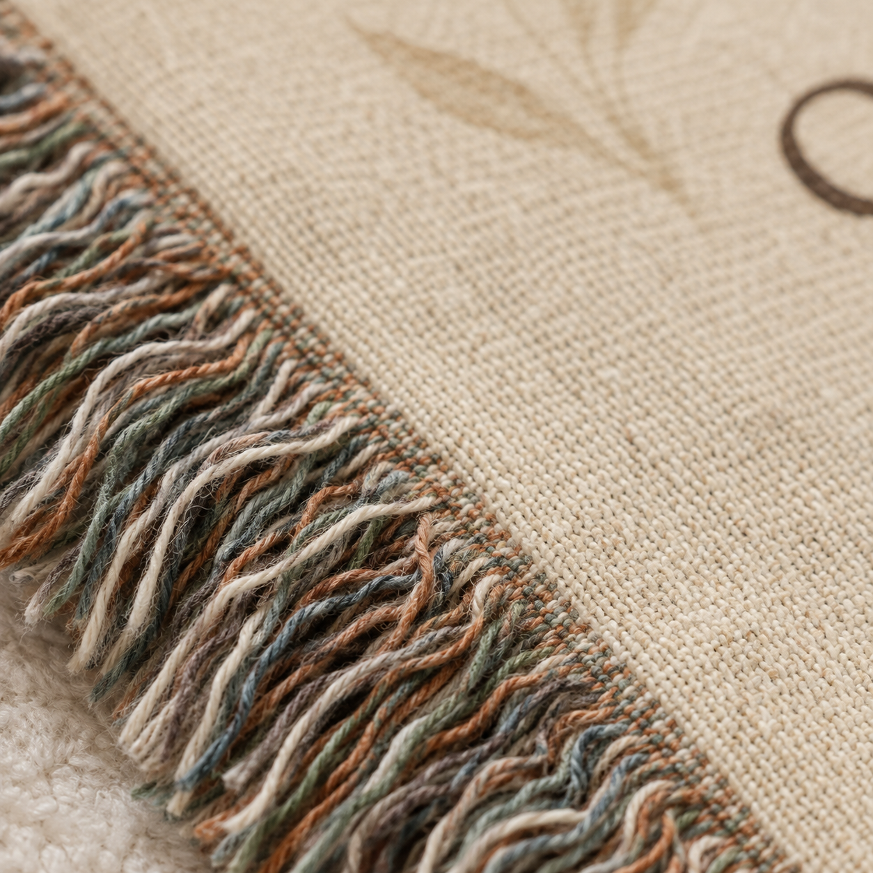 Macro close-up of woven yarn texture and multicolor fringe on John 14:27 Christian blanket