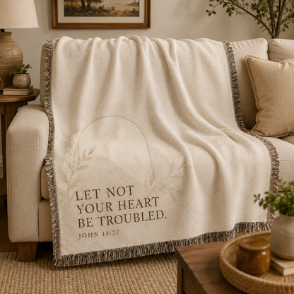 John 14:27 Christian woven blanket softly draped over a neutral sofa with natural folds and fringe