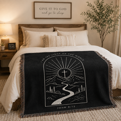 John 8:12 I Am the Light of the World woven blanket styled across a cozy bed