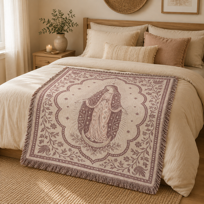 Marian devotion woven blanket styled across a warm boho bedroom