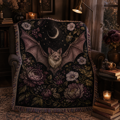 Moonlit bat botanical woven blanket displayed on a reading chair