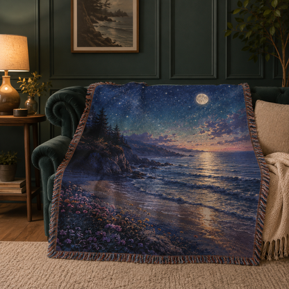 Starry moonlit coast woven tapestry blanket draped over a dark green sofa