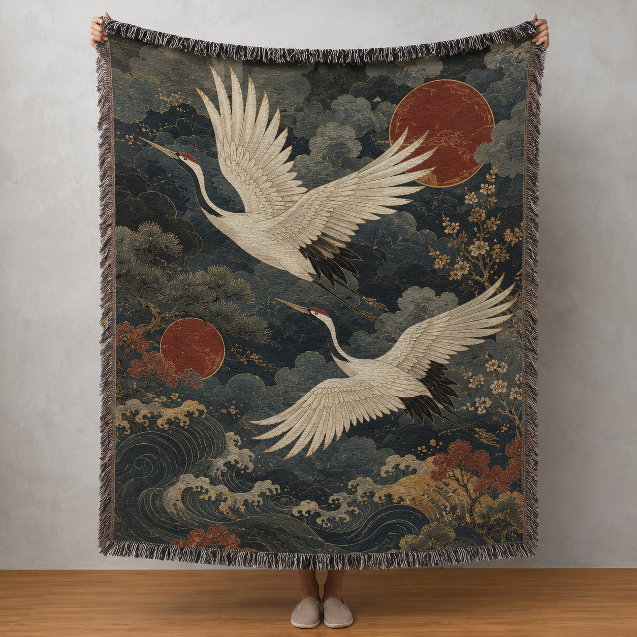 Japanese-inspired woven blanket with two white cranes, red suns, indigo clouds and ocean waves