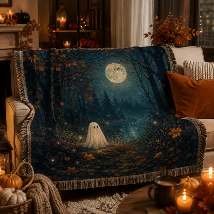 Moonlit ghost forest woven blanket styled on a cozy Halloween living room sofa