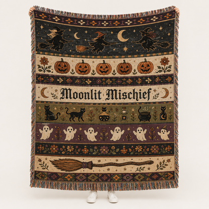 Moonlit Mischief Halloween woven blanket with witches, pumpkins, black cats, ghosts, crescent moons and fringe