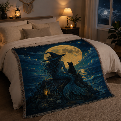 Moonlit sea witch mermaid woven blanket styled across a cozy bedroom bed