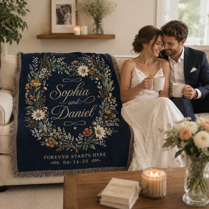 Newlywed couple beside their personalized navy floral woven blanket