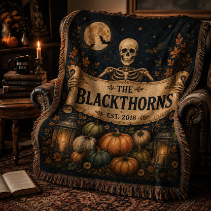 Personalized Halloween family name woven blanket draped over a cozy gothic reading chair
