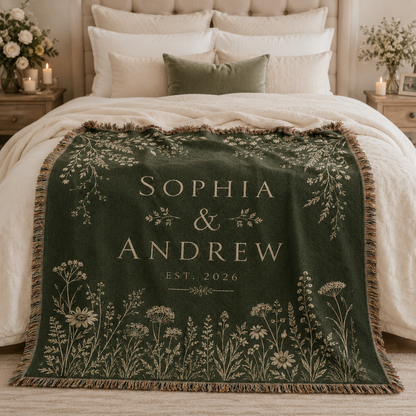 Personalized botanical wedding woven blanket styled across a romantic bedroom bed