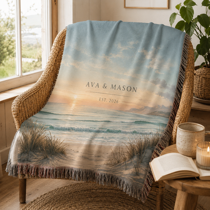 Custom names and established year coastal woven blanket in a cozy reading nook