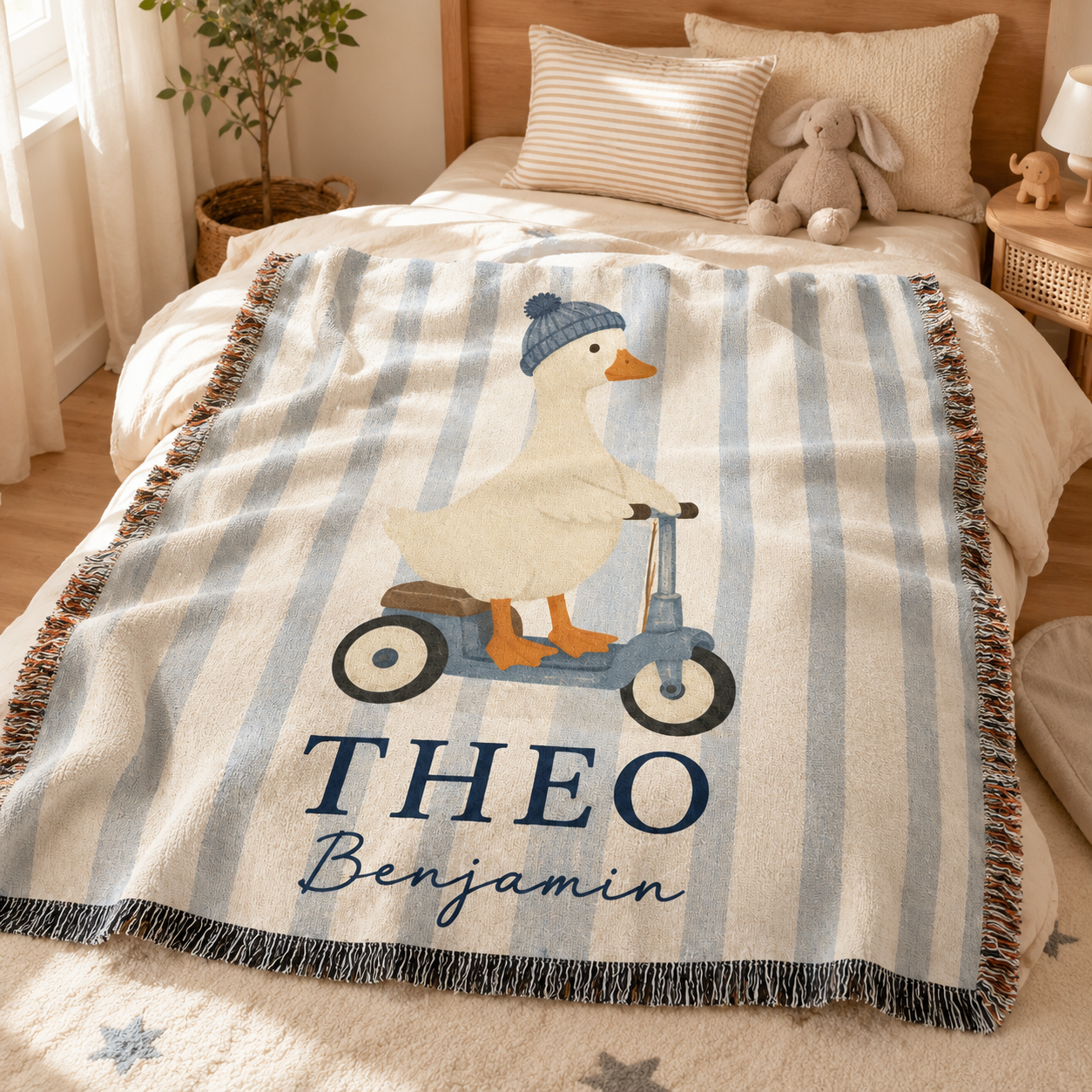 Personalized duck scooter woven blanket styled on a cozy baby boy nursery bed
