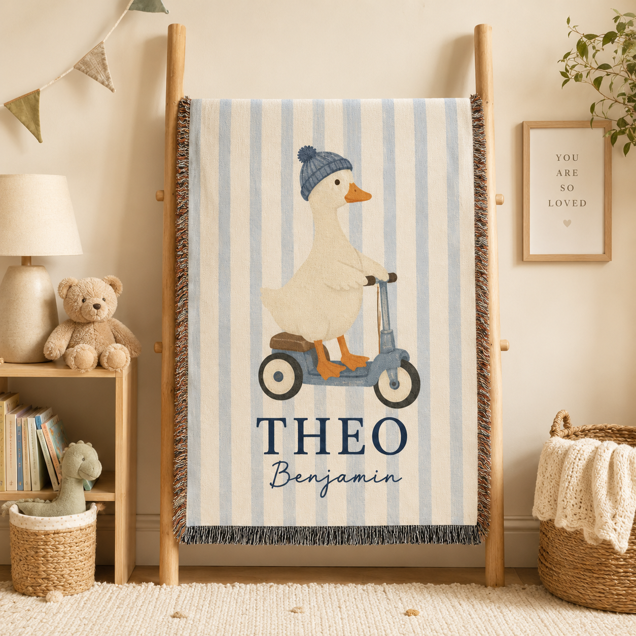 Personalized duck scooter woven blanket displayed on a wooden blanket ladder in a nursery