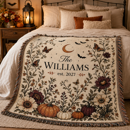 Personalized botanical Halloween woven blanket displayed across a cozy neutral bedroom with lantern light