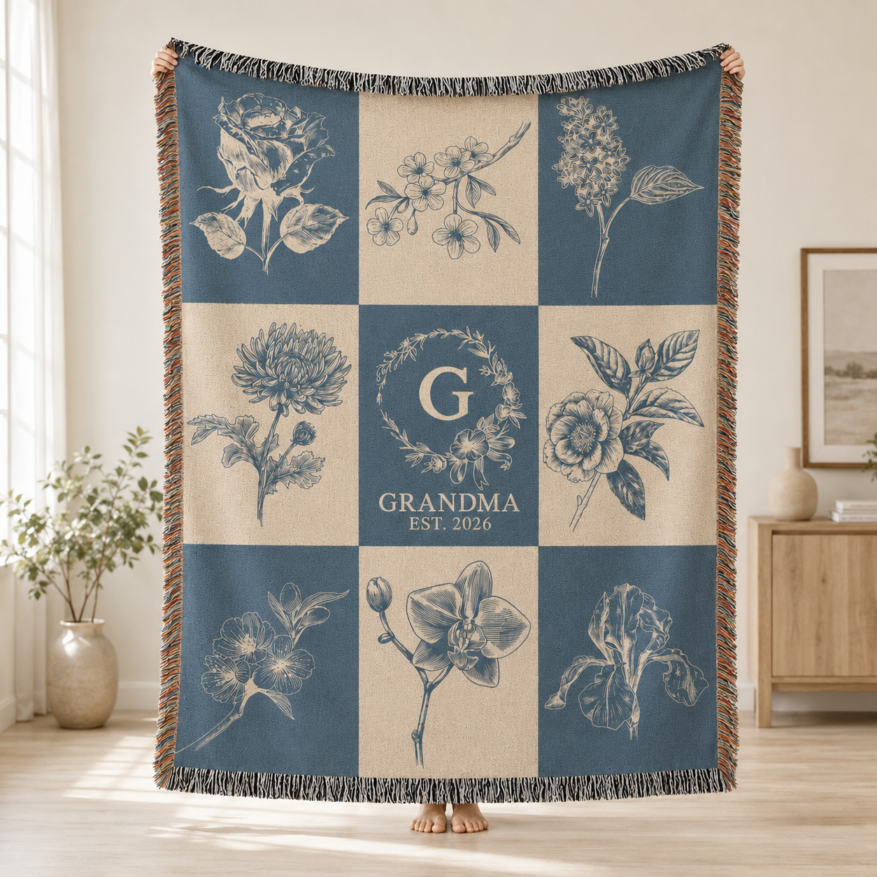 Personalized grandma botanical monogram woven blanket held up to show the full floral grid design