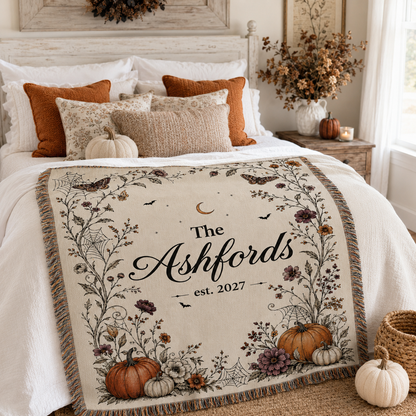 Personalized Halloween family name woven blanket styled across a cozy autumn bedroom bed