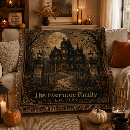 Personalized haunted house woven blanket styled on a cozy sofa with pumpkins and candles