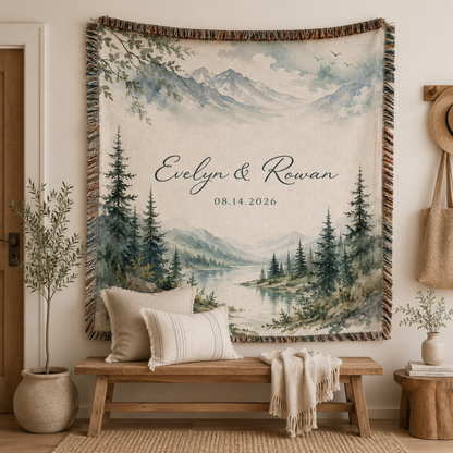 Personalized mountain lake woven blanket displayed as wall tapestry above a rustic wooden bench