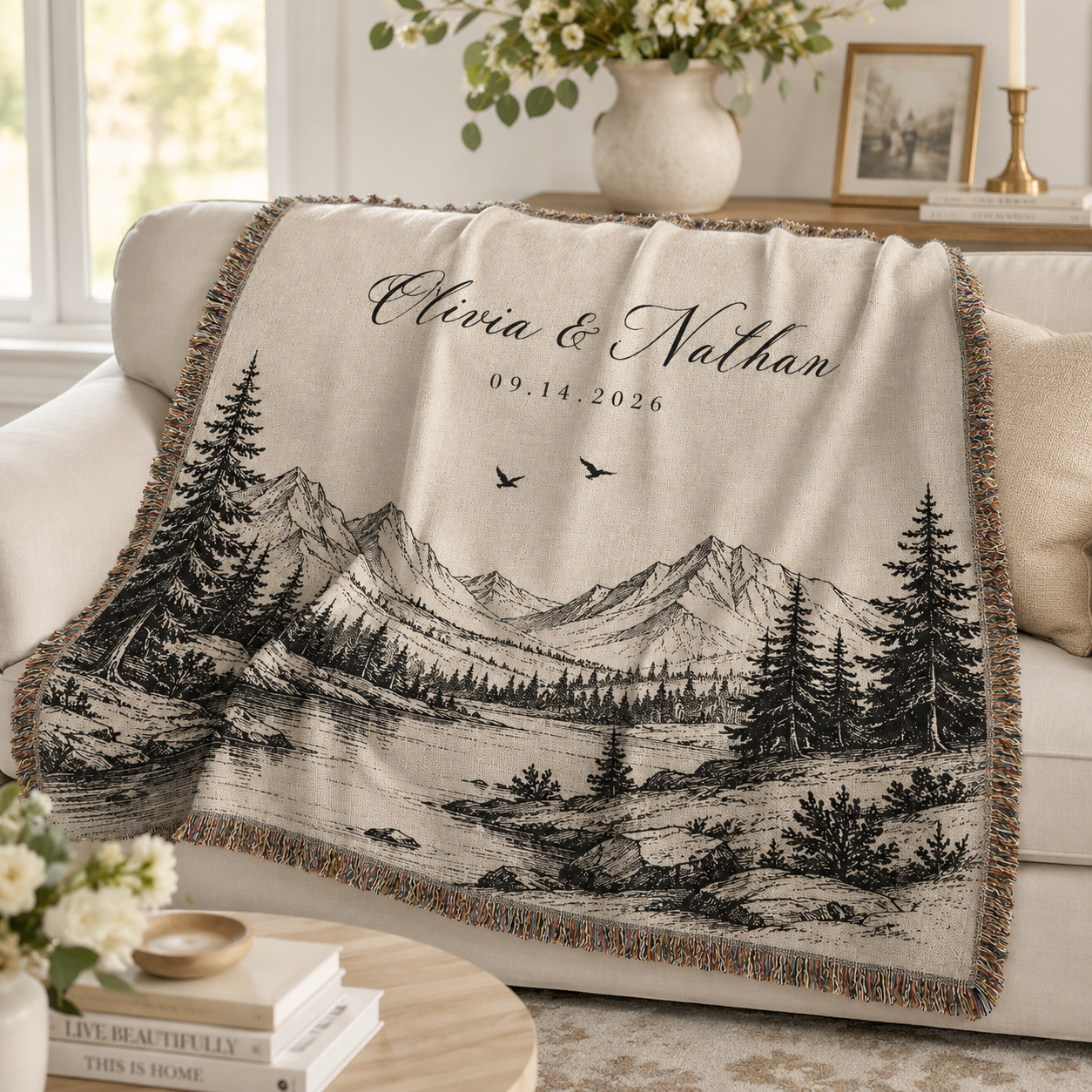 Personalized mountain wedding woven blanket softly draped on a cream sofa