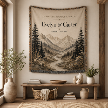 Personalized mountain wedding woven blanket displayed as wall decor above a rustic console in a warm neutral home