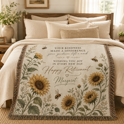 Personalized sunflower retirement woven blanket styled across a warm neutral bedroom bed