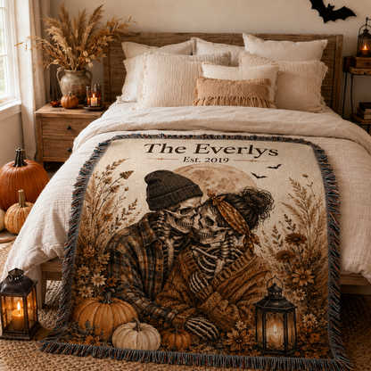 Personalized skeleton couple woven blanket displayed across an autumn bedroom bed