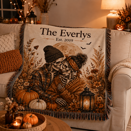 Personalized skeleton couple Halloween woven blanket styled on a cozy sofa