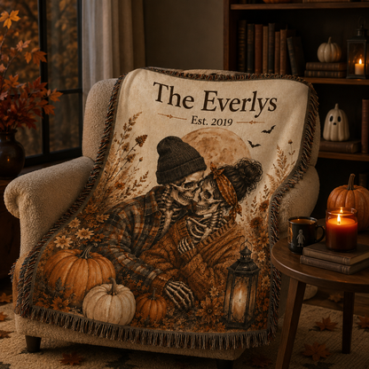 Personalized skeleton couple Halloween woven blanket draped over a cozy reading chair