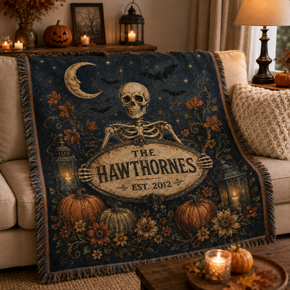 Personalized skeleton family woven blanket styled on a sofa for Halloween