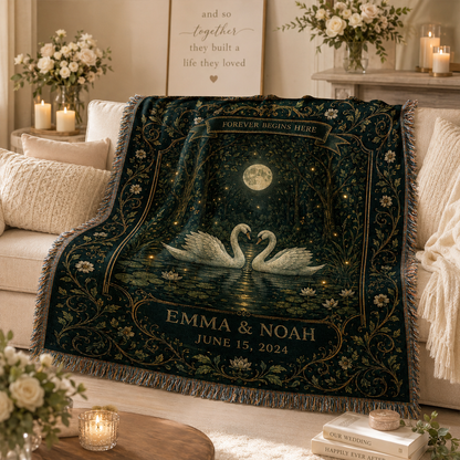 Personalized romantic swan wedding woven blanket softly draped on a cream sofa
