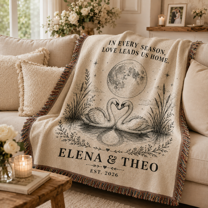 Personalized swan wedding woven blanket softly draped on a neutral sofa