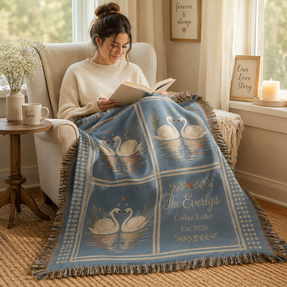 Person using a soft personalized wedding swan woven blanket in a cozy reading nook