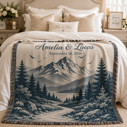 Personalized mountain wedding woven blanket styled across a romantic bedroom bed