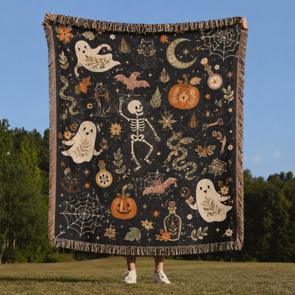 Whimsical Halloween folk art woven blanket with ghosts, skeleton, black cats, pumpkins, bats and fringe